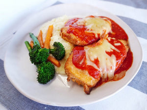 Chicken parmigiana with creamy mash and vegetables