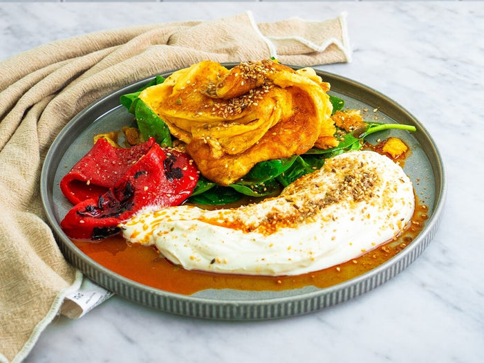 Gourmet scrambled eggs with labneh, roasted peppers and chilli oil